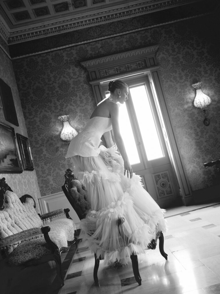 Dolcezza wedding dress side view showing detachable tiered tulle skirt and mini dress structure