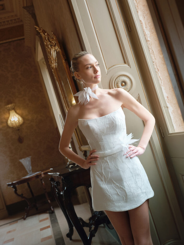 Dolcezza bridal mini dress angled front view with strapless bodice and subtle floral fabric