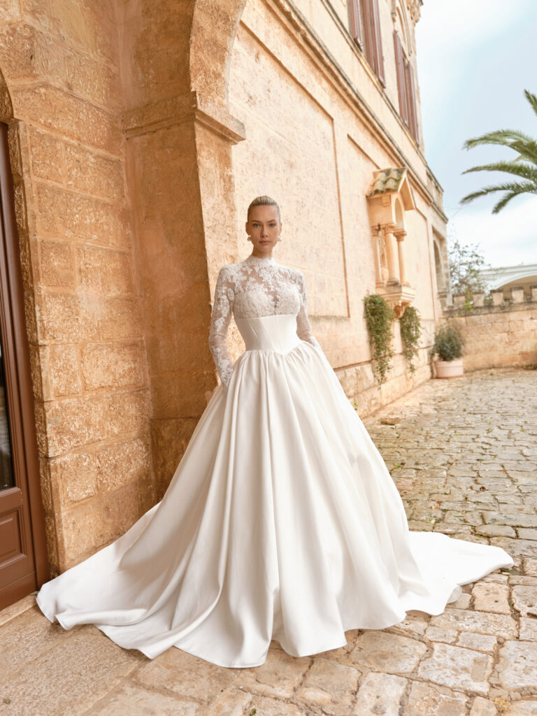 Carissima wedding dress full front view showing high-neck lace bodice, long sleeves and satin ballgown skirt