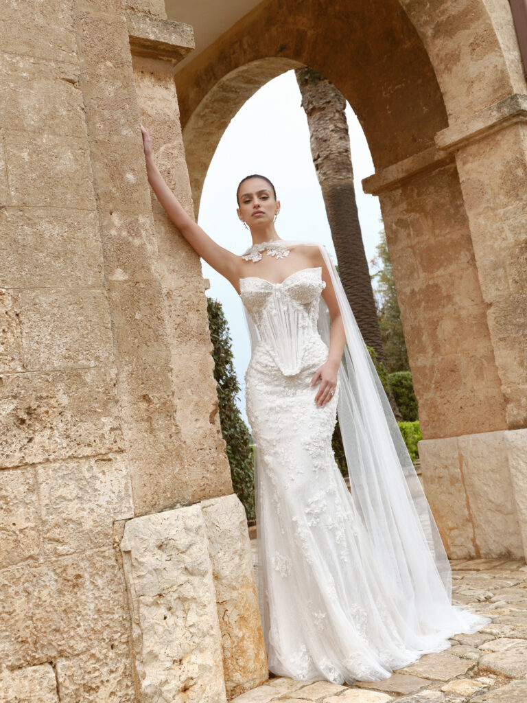 Ti Amo bridal gown full length view with fitted silhouette, floral appliqué and elongated bodice