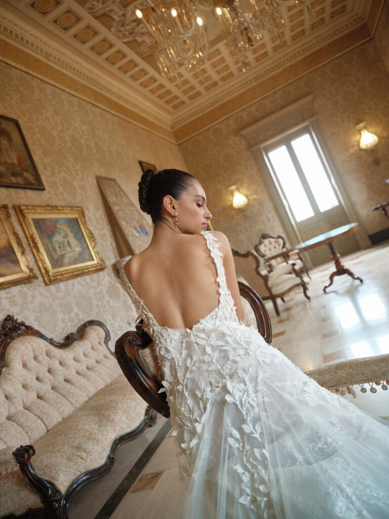 Bella Mia bridal gown back detail showing floral appliqué and soft flowing train