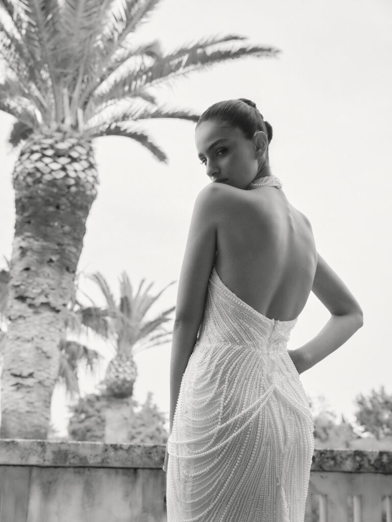 Baci bridal gown back view showing open back, fitted silhouette and pearl beading