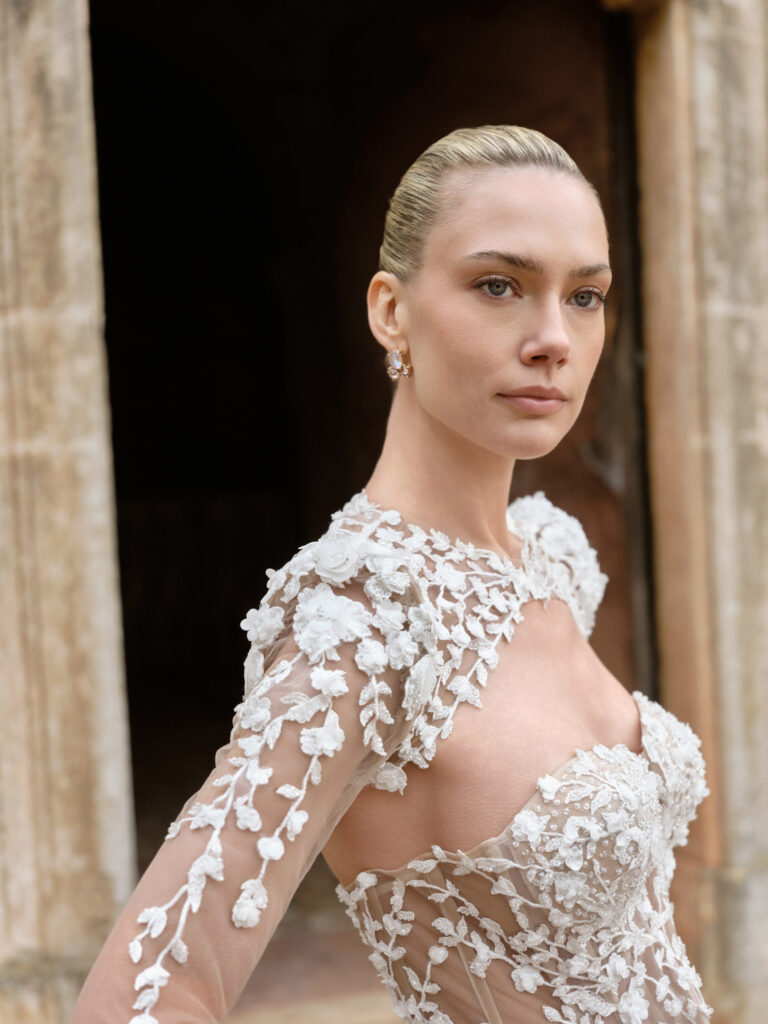 Anima Mia bridal gown illusion bodice with floral appliqué and sheer sleeves