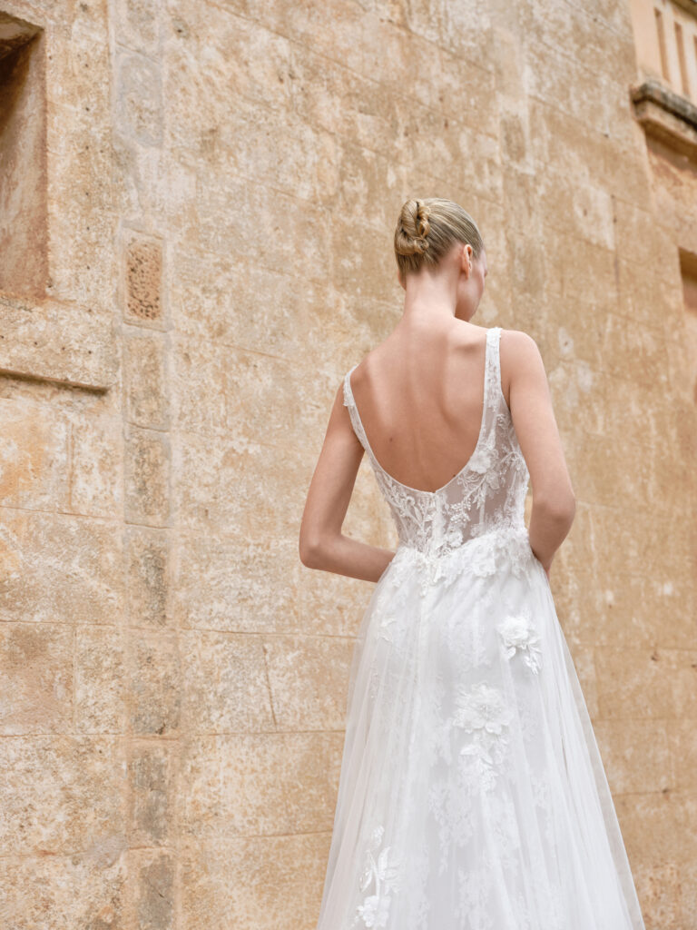 Adora bridal gown back view showing open back, wide straps and soft A-line skirt