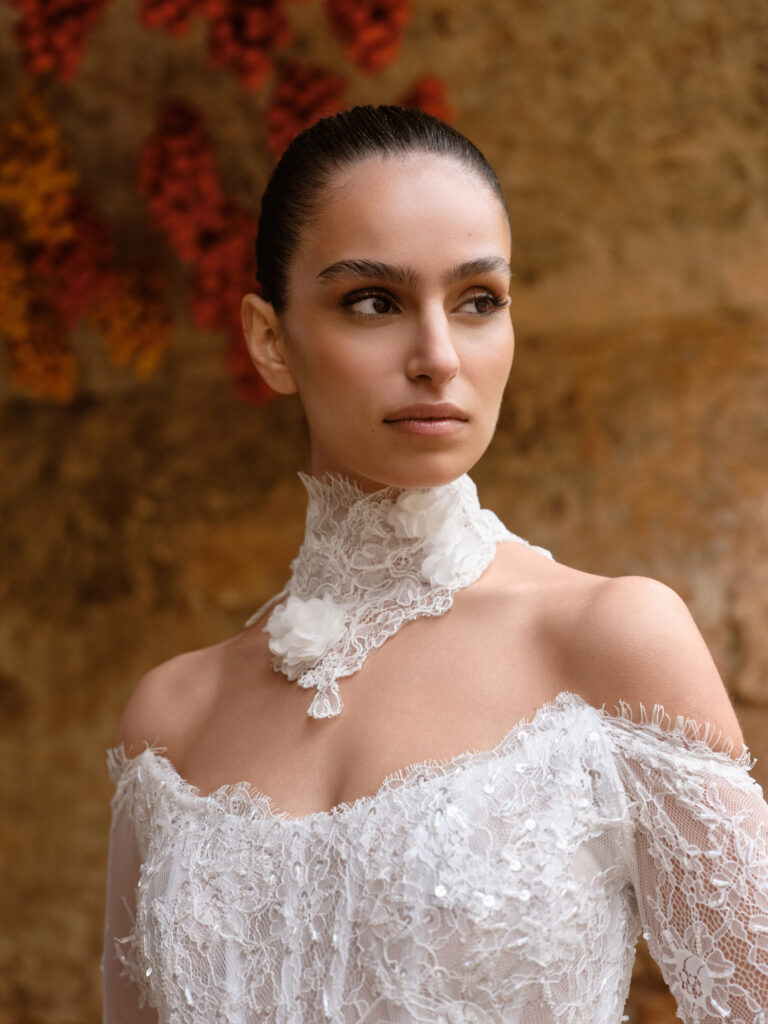 Amore Mio bridal gown close-up showing lace bodice, off-the-shoulder neckline and lace neck scarf detail