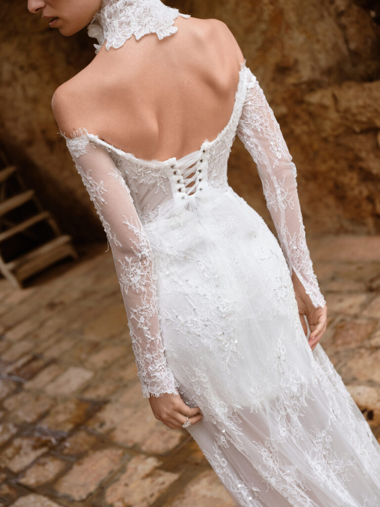 Amore Mio wedding dress detail showing lace texture and sheer long sleeves