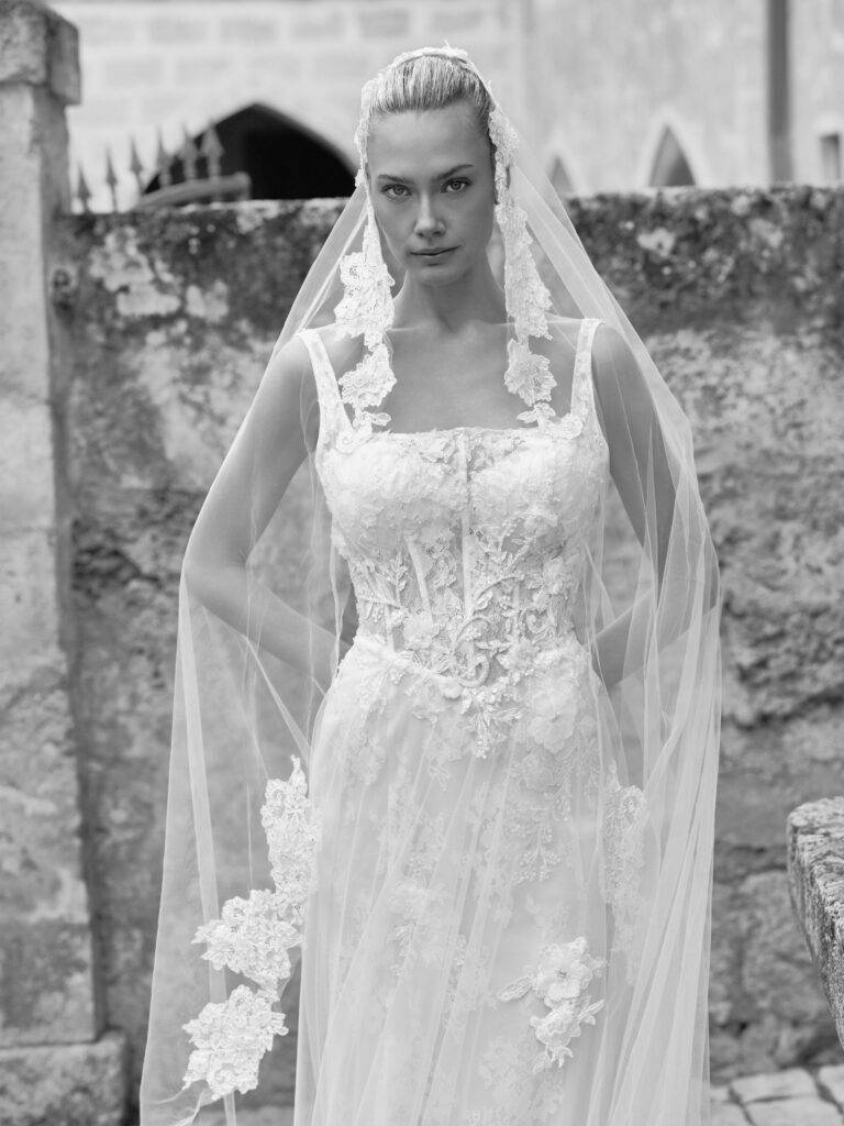 Adora wedding dress front view with square neckline, floral lace bodice and sheer layered skirt