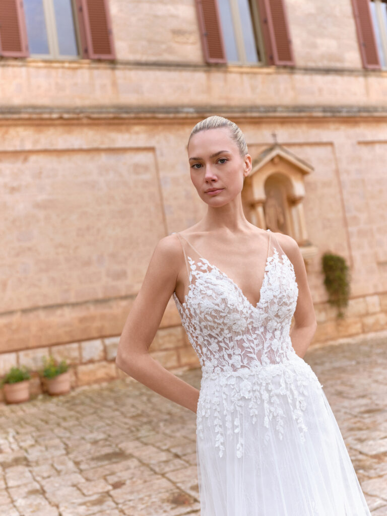 Dolce Amore bridal gown front view with lace bodice and flowing tulle skirt