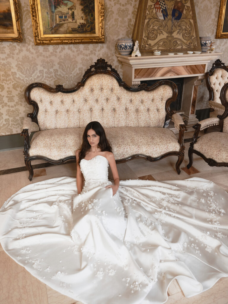 Mia Sposa bridal gown front view showing soft sweetheart bodice and hand-crafted floral embellishment across the full skirt