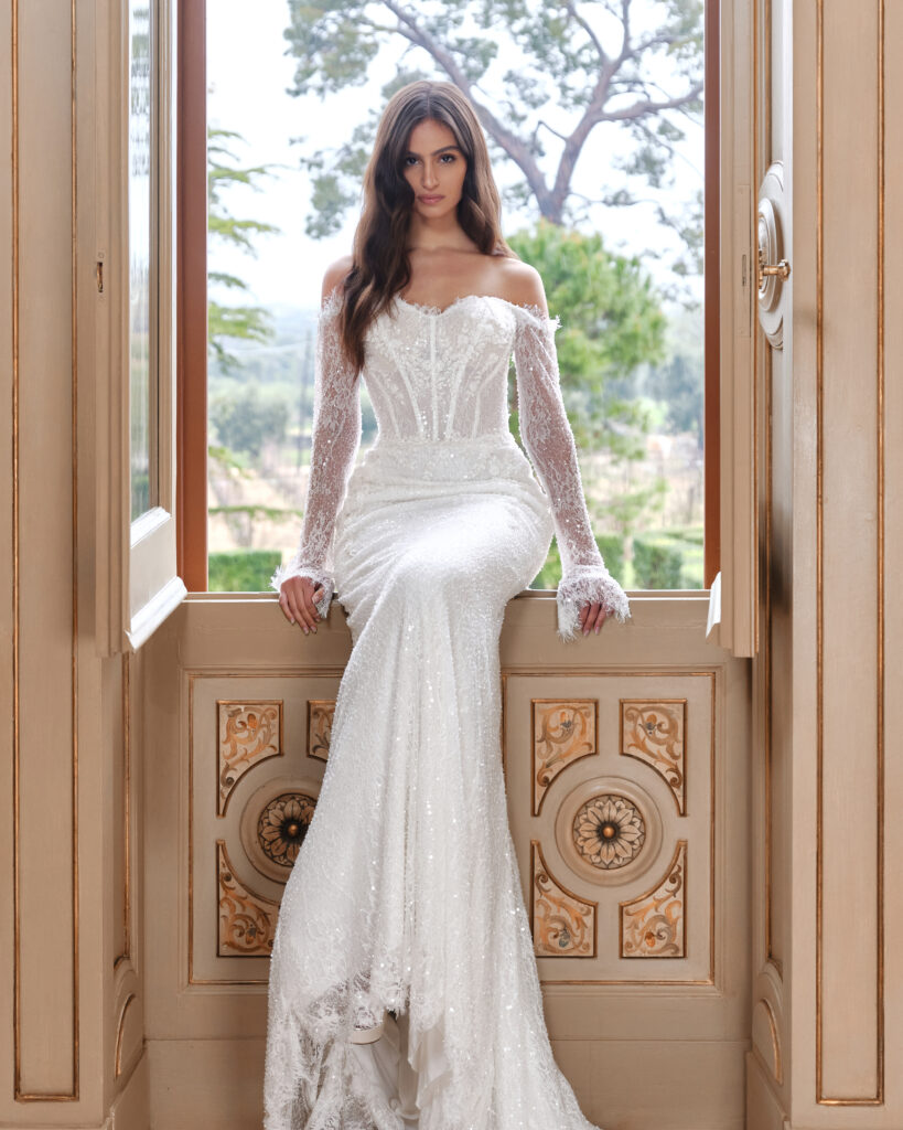 Un Abbraccio wedding dress front view showing fitted shape and off-the-shoulder sleeves